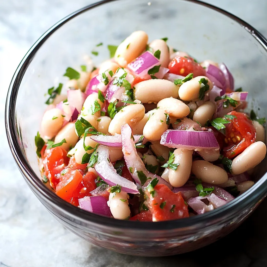 A bowl of food with tomatoes, beans, onions, and parsley.