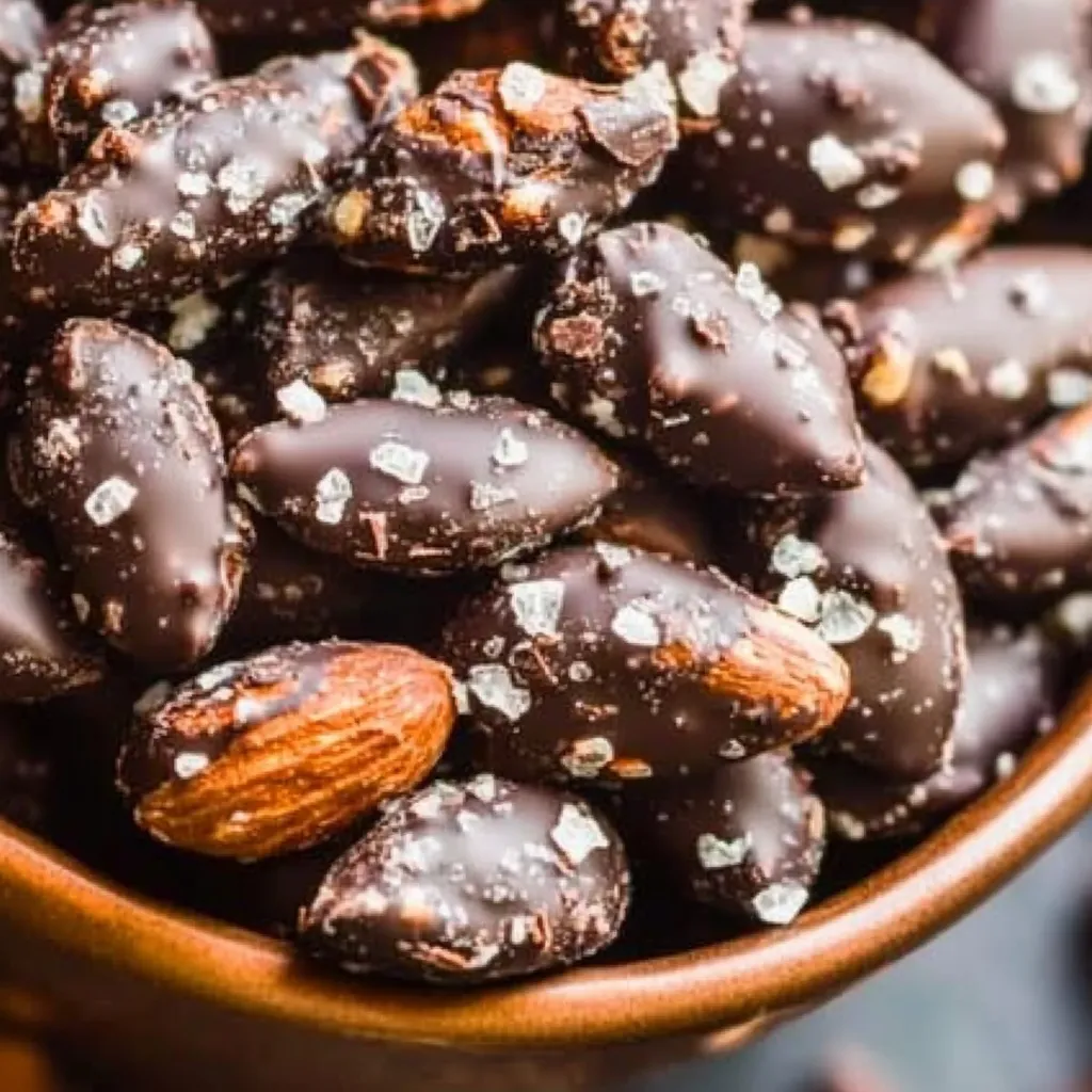 A bowl of chocolate covered almonds.