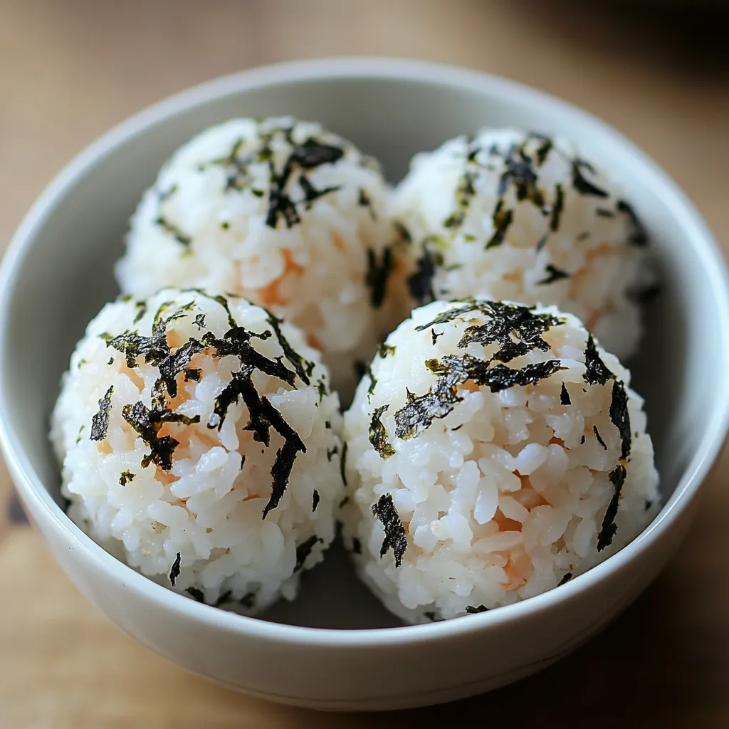 A bowl of rice balls with seaweed on top.