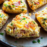 A plate of food with a slice of ham and cheese.