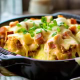 A bowl of food with cheese and bacon.