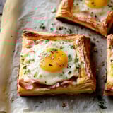 Two quiches with eggs and bacon.