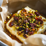 A bowl of food with nuts and raisins on top.